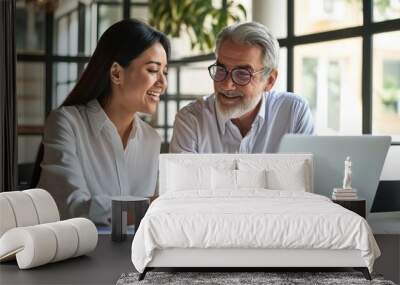 2 multicultural team coworkers, older Latin man executive and young Asian woman manager working together, happy diverse employees looking at laptop computer discussing financial corporate,GenerativeAI Wall mural