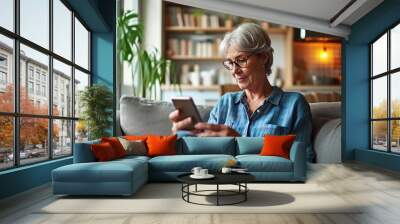 Relaxed mature old 60s woman, older middle aged female customer holding smartphone using mobile app, texting message, search ecommerce offers on cell phone technology device, Generative AI Wall mural