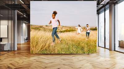 child daughter family happy mother father running active healthy carefree fun together girl walking cheerful field outdoor natur summer Wall mural