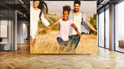 child daughter family happy mother father running active healthy carefree fun together girl walking cheerful field outdoor natur summer Wall mural