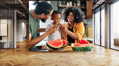 child family kitchen food boy son father mother watermelon fruit slice summer organic meal fun preparing healthy diet eating home black Wall mural