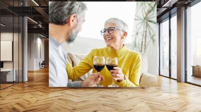 love senior woman couple home wine glass celebration toast wineglass alcohol cheers holiday beverage red romantic anniversary dating toasting valentine eve portrait happy husband wife Wall mural