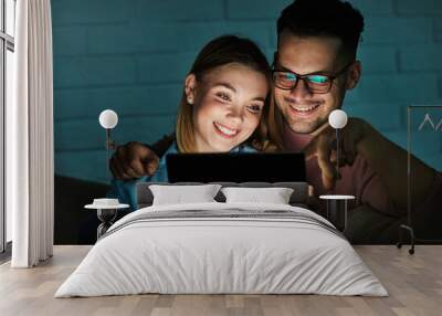 television watching couple tablet night computer young home evening woman man movie entertainment sofa fun happy Wall mural