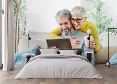 woman couple senior man happy internet love tablet together mature active elderly retirement computer technology online using caucasian home adult family romance Wall mural