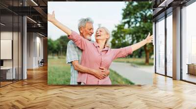 woman man senior couple happy retirement together elderly hug bonding park outdoor park fun smiling love old nature wife happiness active Wall mural