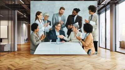 young business people meeting office handshake hand shake shaking hands teamwork group contract signing agreement document signature paperwork success corporate senior mature happy smiling  Wall mural