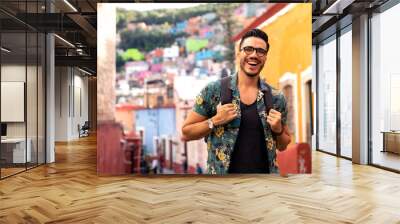 Mexican man traveling in Guanajuato. Student exploring a colorful city.  Wall mural