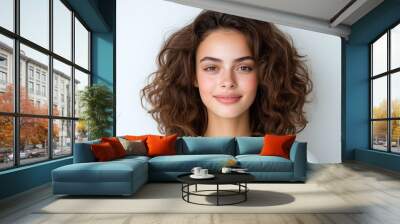 Portrait of a smiling young woman with curly brown hair against a soft white background. Natural beauty and lifestyle concept for wellness marketing, social media content, and banner design with copy  Wall mural