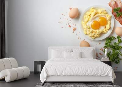 Scrambled eggs with bacon and fresh herbs served on a white plate. A classic breakfast meal featuring eggs, crispy bacon, and parsley, perfect for a hearty morning meal. Wall mural