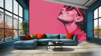 Woman in turtle neck and oversized sunglasses looking up. High-contrast studio portrait with a magenta background. Fashion and elegance concept. Design for magazine cover, fashion editorial, and brand Wall mural