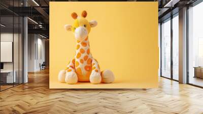 Yellow plush giraffe with orange spots on a yellow background. Studio photography. Wildlife and childhood concept. Design for poster, greeting card Wall mural