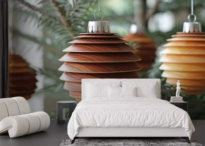 Handmade wooden Christmas ornaments in spiral design hanging in tranquil setting, reflecting modern holiday aesthetic. Wall mural