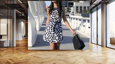 Beautiful brunette shopaholic outdoor city Wall mural