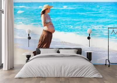 Beautiful pregnant woman on the beach Wall mural