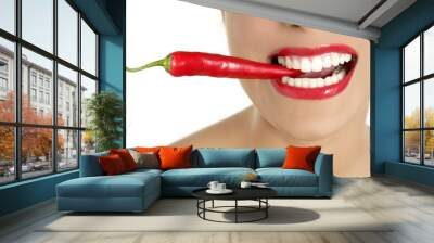 Beautiful woman teeth eating red pepper Wall mural