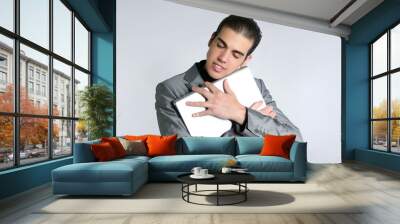 Businessman young embracing computer, hug laptop Wall mural