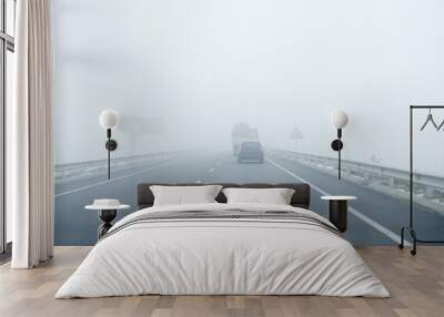 Foggy gray road, cars driving into the fog Wall mural