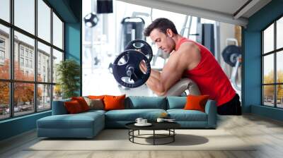 man with weight training equipment on sport gym Wall mural