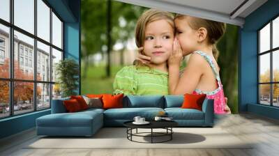 two twin little sister girls whisper in ear Wall mural