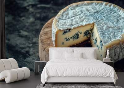 A delicious wheel of blue cheese on a rustic wooden board, showcasing its creamy texture and rich, bold flavor. Wall mural