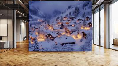 Snow-covered mountain village with illuminated homes at dusk Wall mural