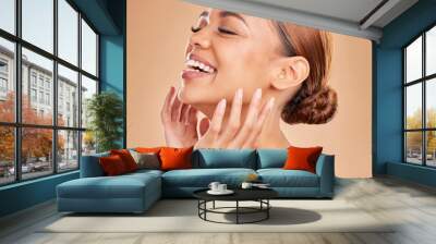 Smile, beauty and a woman with hands on face for skin care glow and shine in studio on brown background. Aesthetic female model laugh and satisfied with spa facial, dermatology cosmetic and wellness Wall mural