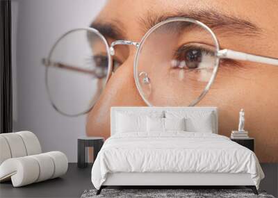 Zoom, optometry and face of a man with glasses for vision, intelligence and eyecare. Looking, serious and guy wearing fashionable eyeglasses, showing frame and fit isolated on a studio background Wall mural