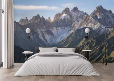 A breathtaking mountainous landscape with jagged peaks covered in snow Wall mural