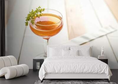 A clear glass filled with a vibrant orange liquid Wall mural