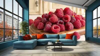 A pile of fresh juicy raspberries on a wooden board Wall mural