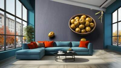 green olives in bowls on dark table Wall mural