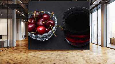 Cherries in a cup and cherry juice in a glass. Berry juice. Wall mural