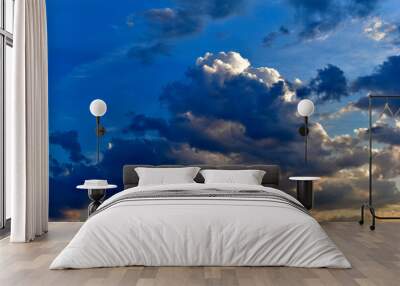 Evening sunset sky with yellow blue clouds and sun rays Wall mural