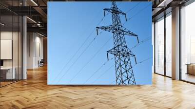 High-voltage power lines against a blue sky background. Towers for the transmission of electricity. Power transmission lines. Wall mural