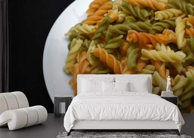 Multicolored pasta on a white plate. Boiled pasta. Wall mural