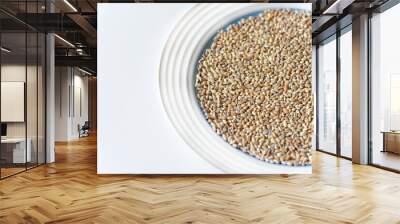 Pearl barley on a white plate close-up Wall mural