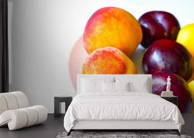 Ripe and juicy peaches and apricots on a white plate Wall mural