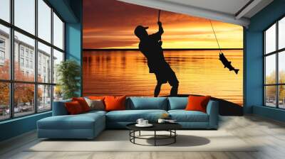 Fisherman with fishing tackle and catching fish at sunrise Wall mural