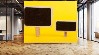 An empty one bulletin board stands against a yellow background Wall mural