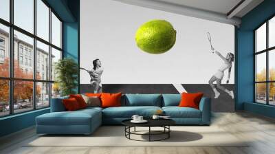 Contemporary art collage with two beautiful girls playing tennis and using lime instead of ball over black and white background Wall mural