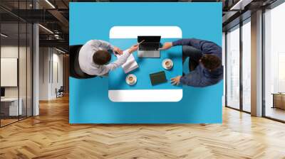 Creative collage. Aerial view of two confident man, entrepreneurs sitting at common table with document and laptop and discussing work tasks. Concept of business lunch, morning meeting, briefing. Ad Wall mural