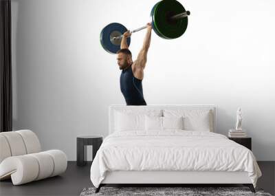 Full length portrait of a man in sportswear exercising with a weight isolated on white background Wall mural