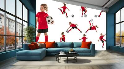 Full-length portrait of little girl, child, training, playing football isolated over white background. Collage Wall mural