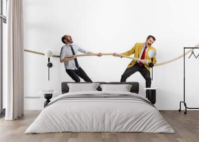 Full-length portrait of two motivated and concentrated employees doing tug of war isolated over white background Wall mural