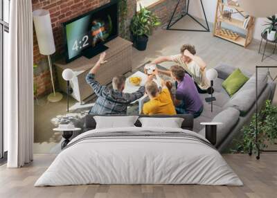 Group of friends watching TV, sport match together. Concept of friendship, leisure activity, emotions Wall mural