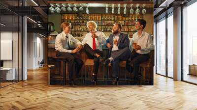 Group portrait of men, professionals in business attire clink their glasses in toast, celebrating success or end of week. Wall mural