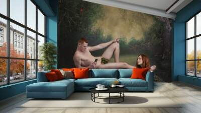 Handsome man holding cell phone taking photo of young pretty woman with long red hair over vintage style background. Modern Adam and Eve Wall mural