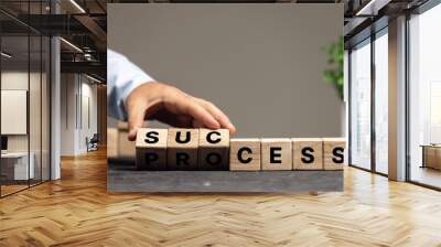 Male hand fliping wooden cubes with word process to success. Copyspace for ad, offer. Wall mural