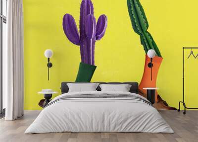 Modern art collage. Two colored cactus wearing different shoes over yellow background. Concept of saving nature. Wall mural