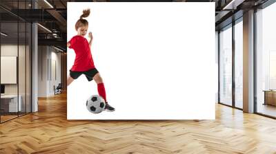 Portrait of athletic, fit child, girl in red uniform playing, training pass technique against transparent background. Sportive and active kid. Concept of action, team sport game, energy, vitality. Wall mural